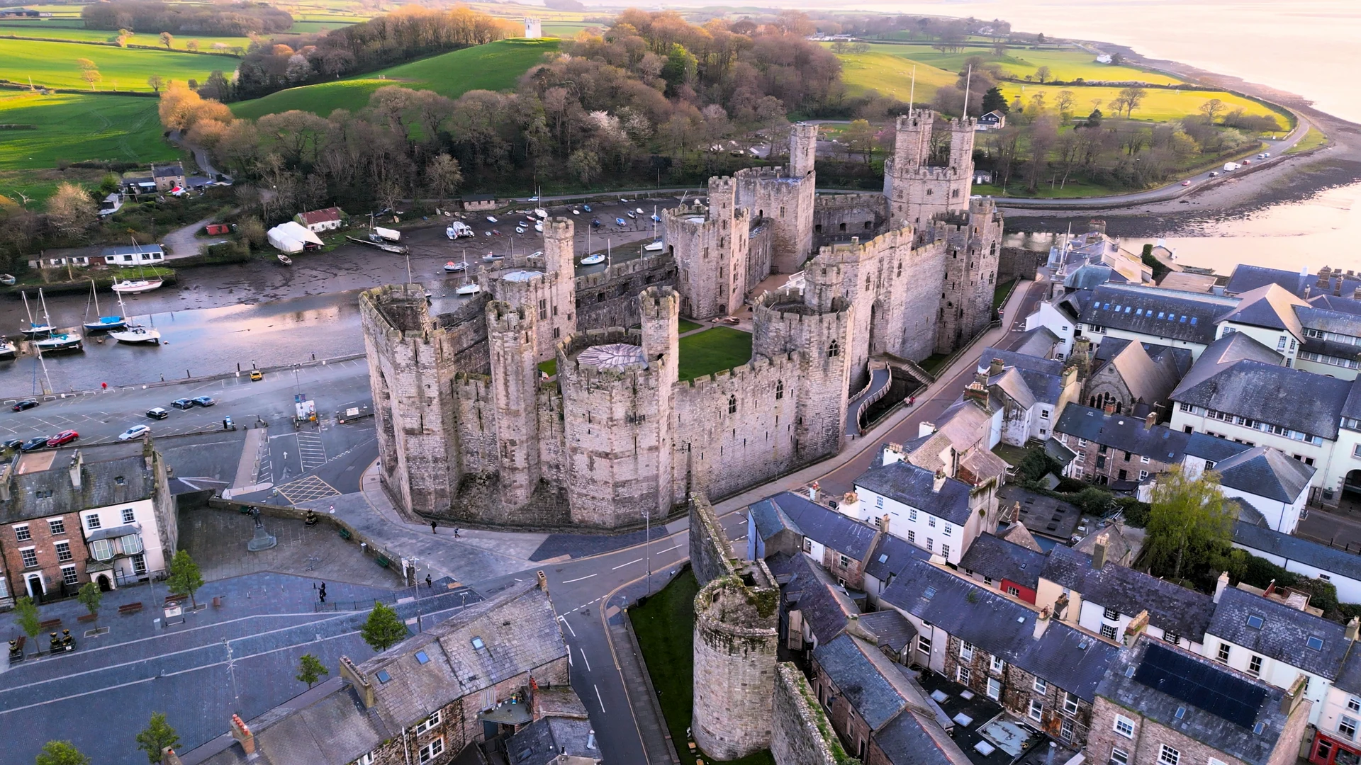 Caernarfon Castle at dusk, Gwynedd — gateway to the town that is home to Caernarfon Town FC