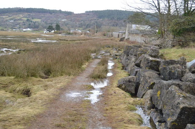 Family-friendly Red Wharf Bay on Anglesey's coast path, featuring golden sands and calm waters.