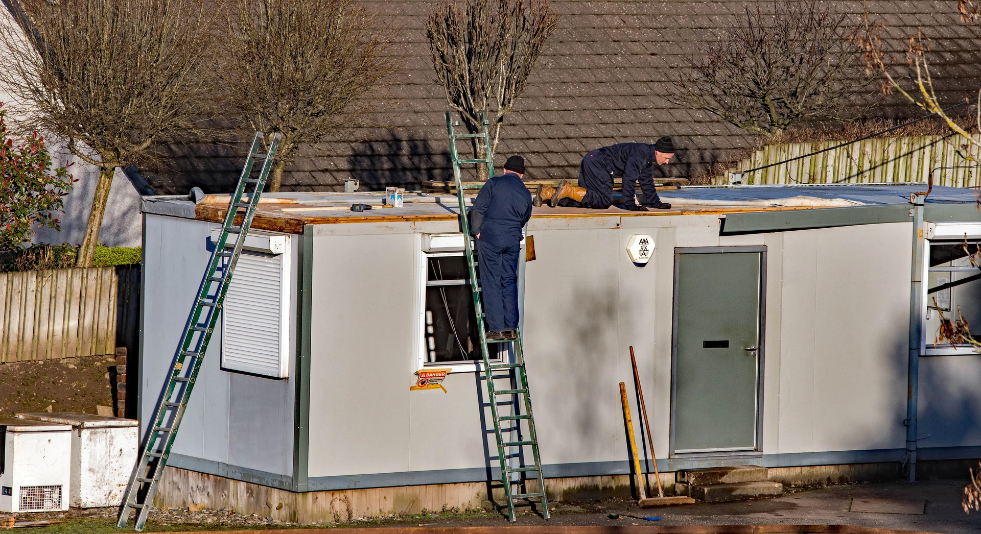 A roofer working on a tiled roof
